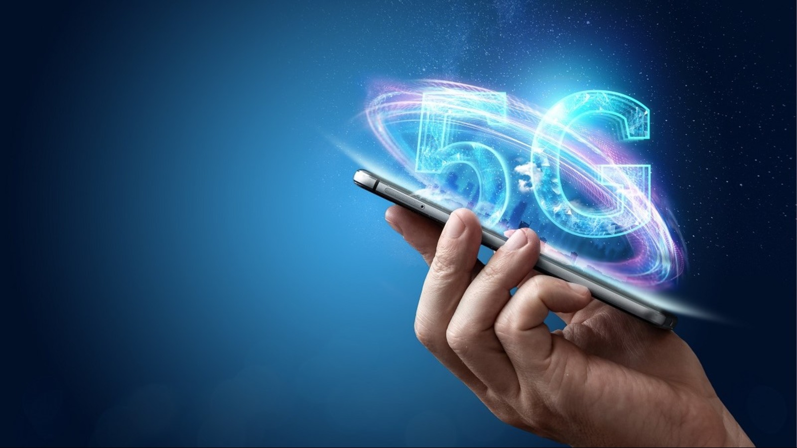 A hand holding a smartphone against a blue background, with a glowing holographic 5G logo and swirling light rings emanating from the screen.