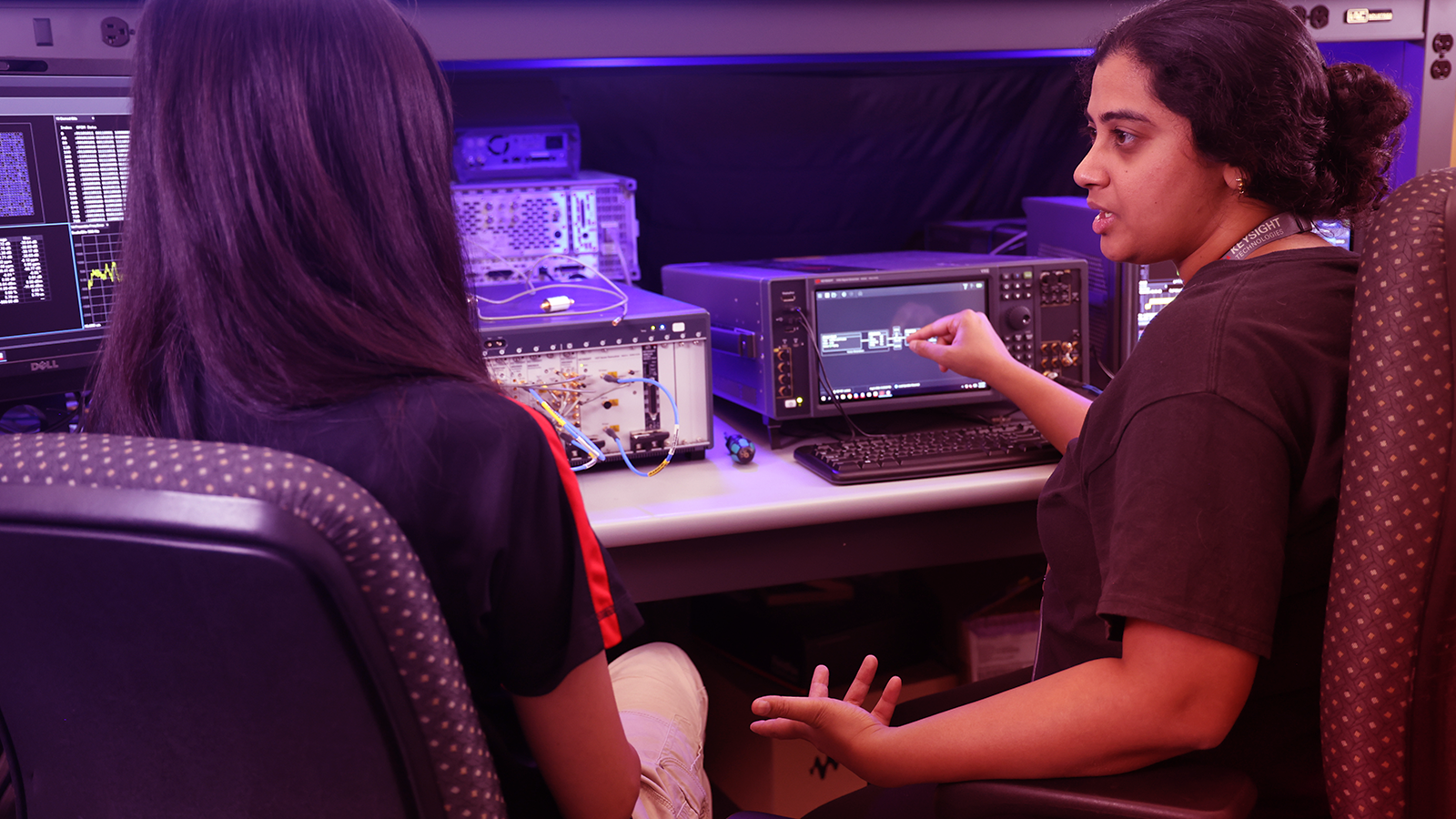 Two professionals viewing hardware device