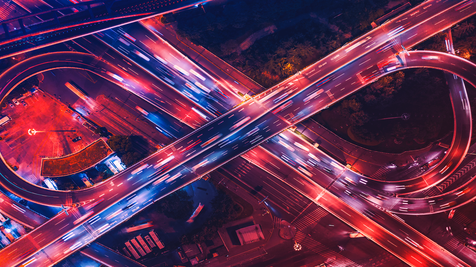 Highway overpass shows car headlights speeding